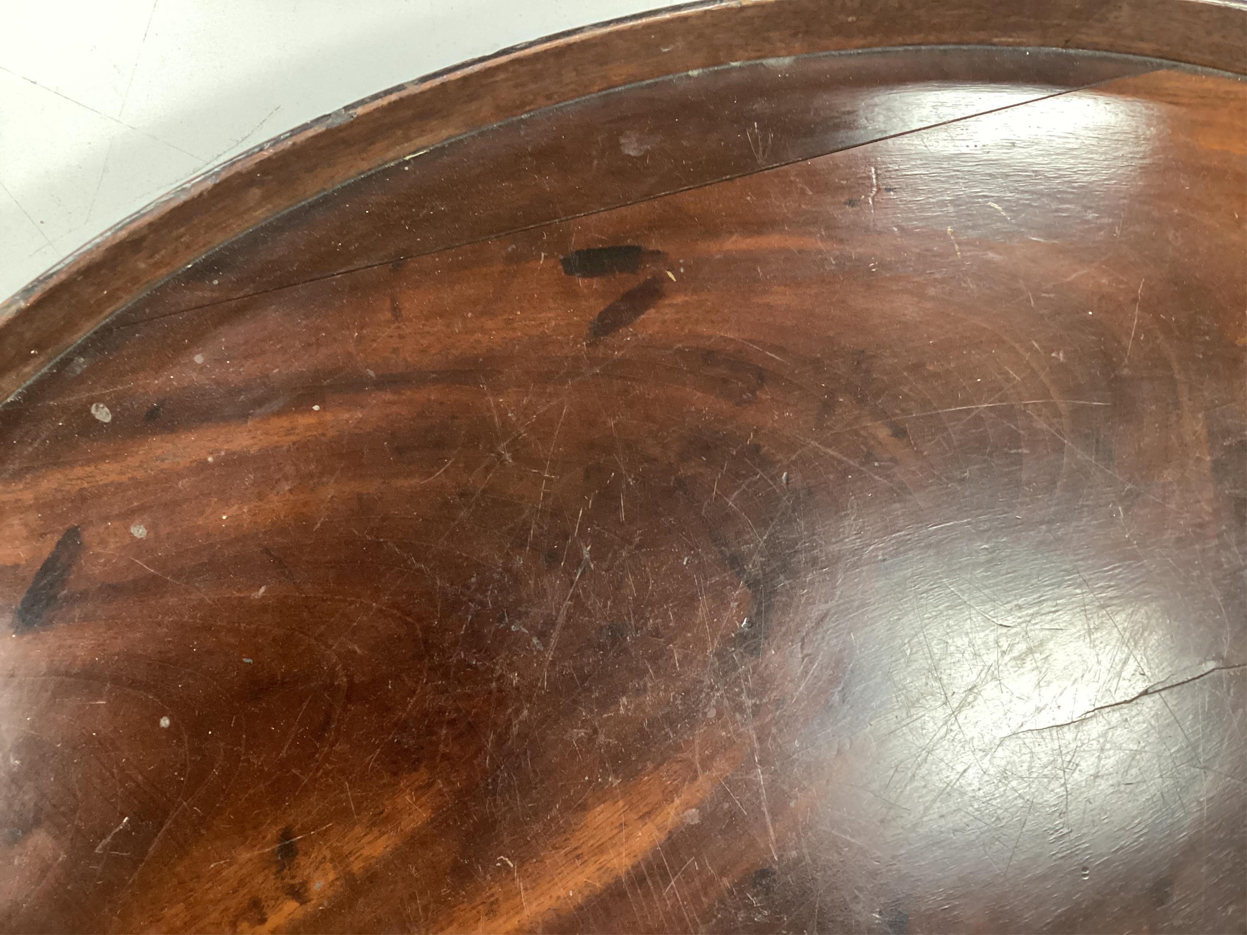 A Georgian oval mahogany two handled tea tray, width 73cm, depth 52cm. Condition poor, warped